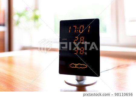 Hot summer day. High temperatures showing on display of  home meteo station 98110656