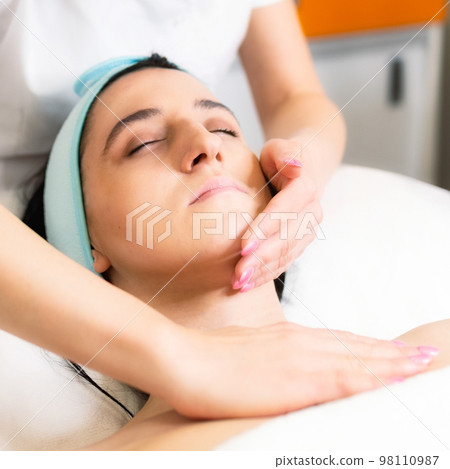 Beautiful young woman receiving massage in spa Beautiful young woman receiving massage in spa 98110987