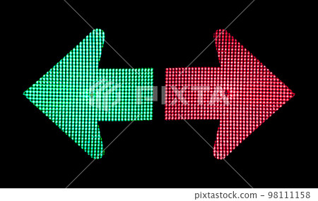 Right and wrong direction. Decision concept. Green arrow showing left and red arrow showing right on traffic lights on black background Right and wrong direction. Decision concept. Green arrow showing left and red arrow showing right on traffic lights on black background 98111158