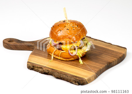 Tasty american burger on wooden serving board 98111163
