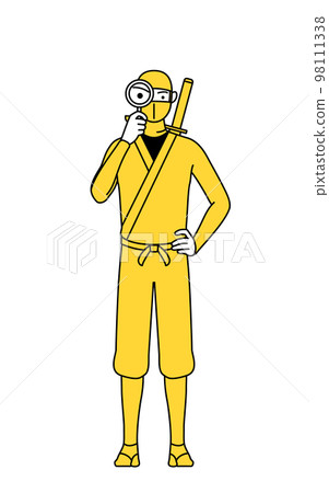 A man in a ninja costume looking through a magnifying glass 98111338