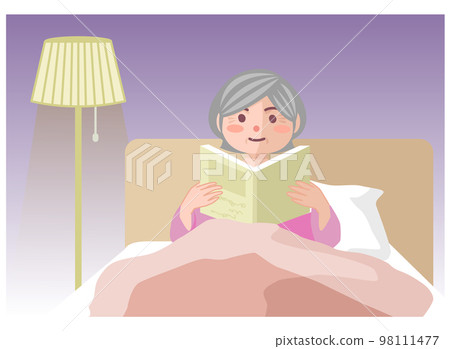 Elderly woman reading in bed at night Elderly woman reading in bed at night 98111477
