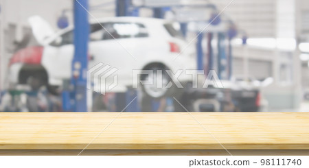 Empty wood table top with car service centre auto repair workshop blurred background Empty wood table top with car service centre auto repair workshop blurred background 98111740