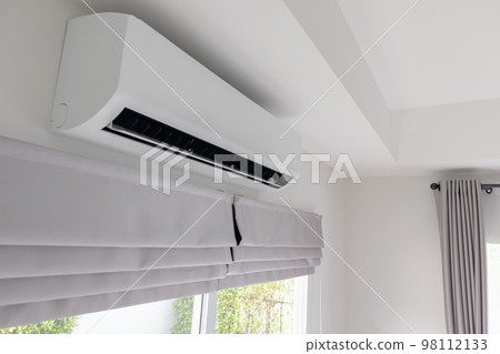 Air conditioner on white wall room interior background 98112133