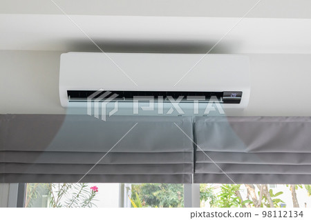 Air conditioner on white wall room interior background 98112134