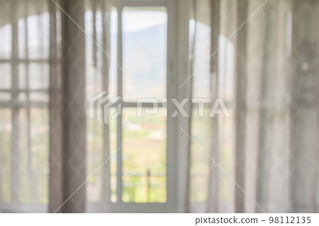 window curtain with green garden abstract blur background 98112135