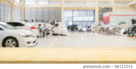 Empty wood table top with car service centre auto repair workshop blurred background Empty wood table top with car service centre auto repair workshop blurred background 98112551