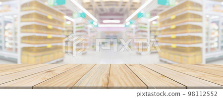 Wood table top with supermarket grocery store aisle interior blurred background with bokeh light for product display Wood table top with supermarket grocery store aisle interior blurred background with bokeh light for product display 98112552