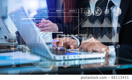 Businessman hand Project manager working and update tasks and Gantt chart scheduling virtual diagram.with smart phone, tablet and laptop in office.. 98113431