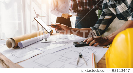 Engineer people meeting working in modern office for discussing, engineering .Hands of Engineer working on blueprint Construction concept. 98113447