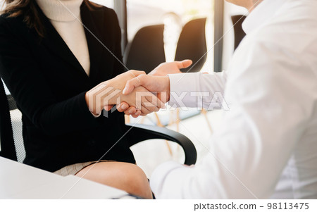 Two confident business man shaking hands during a meeting in the office, success, dealing, greeting and partner Two confident business man shaking hands during a meeting in the office, success, dealing, greeting and partner 98113475