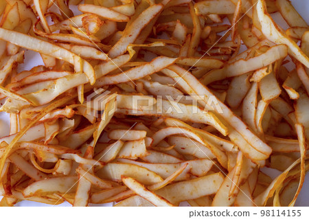 Dried squid strips with peppers all over the background Dried squid strips with peppers all over the background 98114155