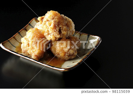 Tatsuta-age chicken with ponzu sauce and grated daikon radish on a black background Tatsuta-age chicken with ponzu sauce and grated daikon radish on a black background 98115039