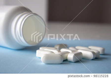 Magnesium Vitamins And Jar On a Blue Background. Blank space for the inscription on the tablet Magnesium Vitamins And Jar On a Blue Background. Blank space for the inscription on the tablet 98115228