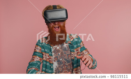 Man using virtual reality headset helmet app to play simulation innovation 3D game in VR goggles 98115511
