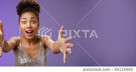 Amused elegant woman looking desire extend arms widen eyes impressed gasping extend arms towards camera hug give embrace cannot resist temptetion standing blue background 98116469