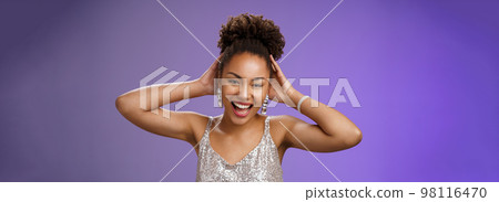 Joyful lucky african-american charming woman celebrating finish university enjoying party having fun dancing touching haircut optimistic smiling broadly enjoy wealthy lifestyle blue background 98116470