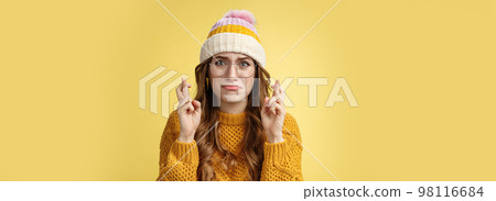 Nervous insecure unconfident cute nerd girl university student wearing glasses sulking cry, whining worried cross fingers good luck praying dream come true standing intense yellow background Nervous insecure unconfident cute nerd girl university student wearing glasses sulking cry, whining worried cross fingers good luck praying dream come true standing intense yellow background 98116684