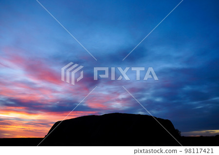 Beautiful sunset sky and silhouette of Ayers Rock (Uluru) Beautiful sunset sky and silhouette of Ayers Rock (Uluru) 98117421