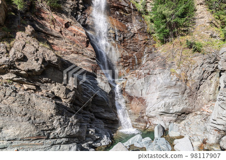 Bright view of flowing Lillaz waterfall with resulted pond beneath and granite karst rocks Bright view of flowing Lillaz waterfall with resulted pond beneath and granite karst rocks 98117907