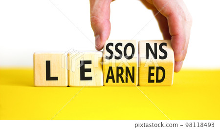 Lessons to learn symbol. Concept word Lessons learn on wooden cubes. Beautiful yellow table white background. Businessman hand. Business education and lessons to learn concept. Copy space. Lessons to learn symbol. Concept word Lessons learn on wooden cubes. Beautiful yellow table white background. Businessman hand. Business education and lessons to learn concept. Copy space. 98118493