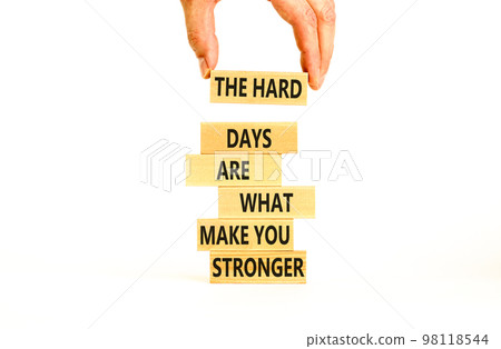 Support and be stronger symbol. Concept words The hard days are what make you stronger on wooden blocks. Bussinesman hand. Beautiful white background. Business and be stronger concept. Copy space. 98118544