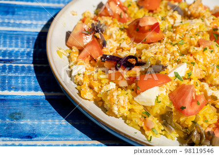Plate with homemade chicken salad, carrot, tomato and brown rice on a rustic blue wooden table. heatly food. Plate with homemade chicken salad, carrot, tomato and brown rice on a rustic blue wooden table. heatly food. 98119546