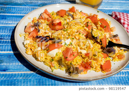 Plate with homemade chicken salad, carrot, tomato and brown rice on a rustic blue wooden table. heatly food. Plate with homemade chicken salad, carrot, tomato and brown rice on a rustic blue wooden table. heatly food. 98119547