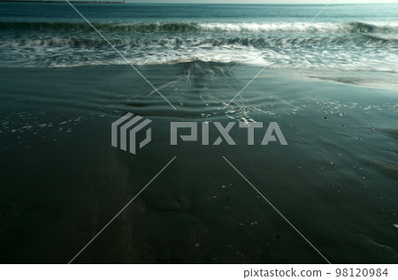 The sea is still early in spring. Waves came and went slowly. The patterns created by the waves are ever-changing, and I never get tired of seeing them. The sea is still early in spring. Waves came and went slowly. The patterns created by the waves are ever-changing, and I never get tired of seeing them. 98120984