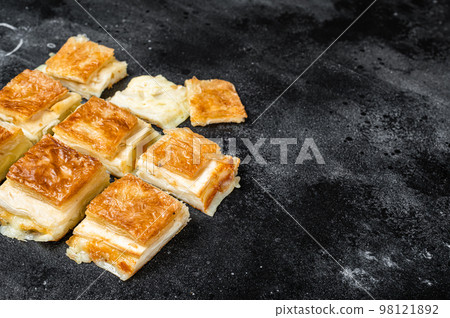 Turkish Su Boregi, Tabla borek or burek with cheese. Black background. Top view. Copy space 98121892