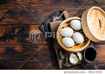 Black Century eggs, preserved duck egg, Chinese cuisine. Wooden background. Top view. Copy space Black Century eggs, preserved duck egg, Chinese cuisine. Wooden background. Top view. Copy space 98121931