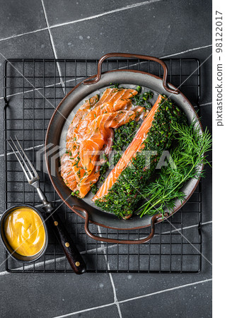 Pickled Salmon fillet with dill, salt and papper, gravlax. Black background. Top view Pickled Salmon fillet with dill, salt and papper, gravlax. Black background. Top view 98122017