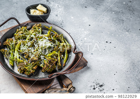 Roast Broccolini cabbage with crispy parmesan cheese. White background. Top view. Copy space 98122029