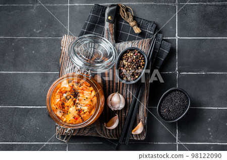 Homemade kimchi in a glass jar, traditional Korean cuisine. Black background. Top view Homemade kimchi in a glass jar, traditional Korean cuisine. Black background. Top view 98122090