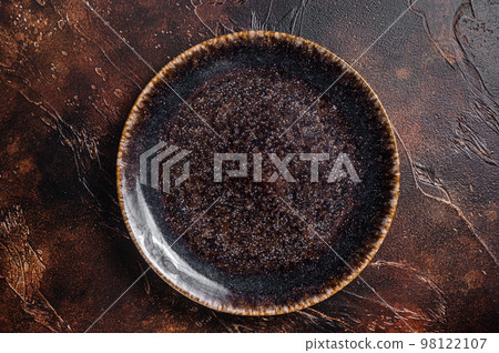 Table setting with vintage empty black plate on rustic wood. Dark background. Top view. Copy space Table setting with vintage empty black plate on rustic wood. Dark background. Top view. Copy space 98122107