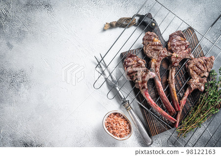Barbecue grilled lamb meat chop on a grill, mutton rib cutlet. White background. Top view..Copy space Barbecue grilled lamb meat chop on a grill, mutton rib cutlet. White background. Top view..Copy space 98122163