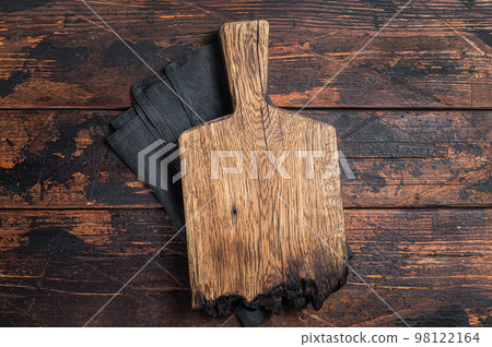Empty wooden Cutting board over towel on kitchen table, healthy cooking background. Wooden background. Top view. Copy space 98122164