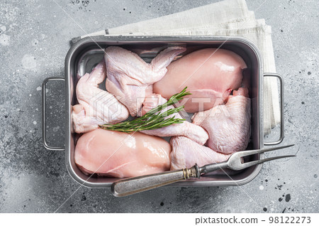 Raw chicken meat parts with spices and rosemary ready for cooking. Gray background. Top view 98122273