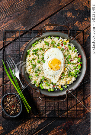 Fried rice with eggs, corn, pea and spice. Wooden background. Top view 98122498