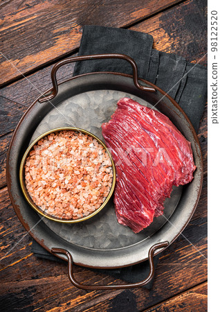 Raw Game meat of Venison dear, meat steak. Wooden background. Top view 98122520