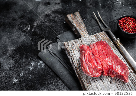 Raw Venison dear steak ready for cooking. Black background. Top view. Copy space 98122585