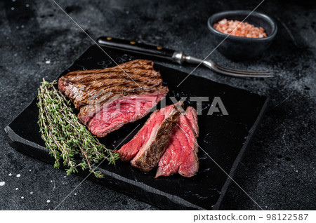 Grilled Wild Venison steak with thyme and salt, game meat. Black background. Top view 98122587