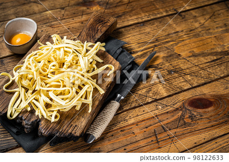 Cooking raw spaetzle egg noodle. Wooden background. Top view. Copy space 98122633
