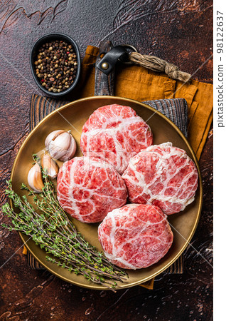 Raw french meatballs cutlet with spices and herbs. Dark background. Top view 98122637
