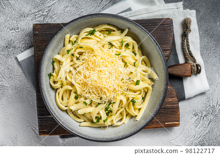 Spaetzle German egg noodles with cheese served with parsley. White background. Top view 98122717