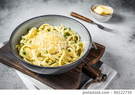 Spaetzle German egg noodles with cheese served with parsley. White background. Top view 98122730