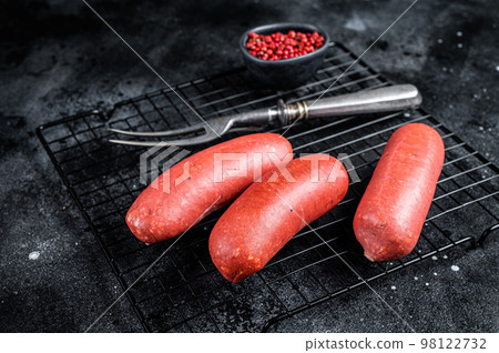 Turkish Sucuk beef meat sausage. Black background. Top view Turkish Sucuk beef meat sausage. Black background. Top view 98122732