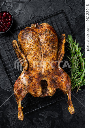 Roast whole duck, festive christmas recipe. Black background. Top view 98122948