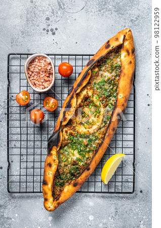 Turkish pide, traditional pie with beef meat and vegetables. White background. Top view 98122959