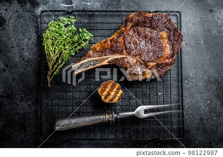 BBQ Grilled Tomahawk or rib eye with bone beef steak. Black background. Top view 98122987
